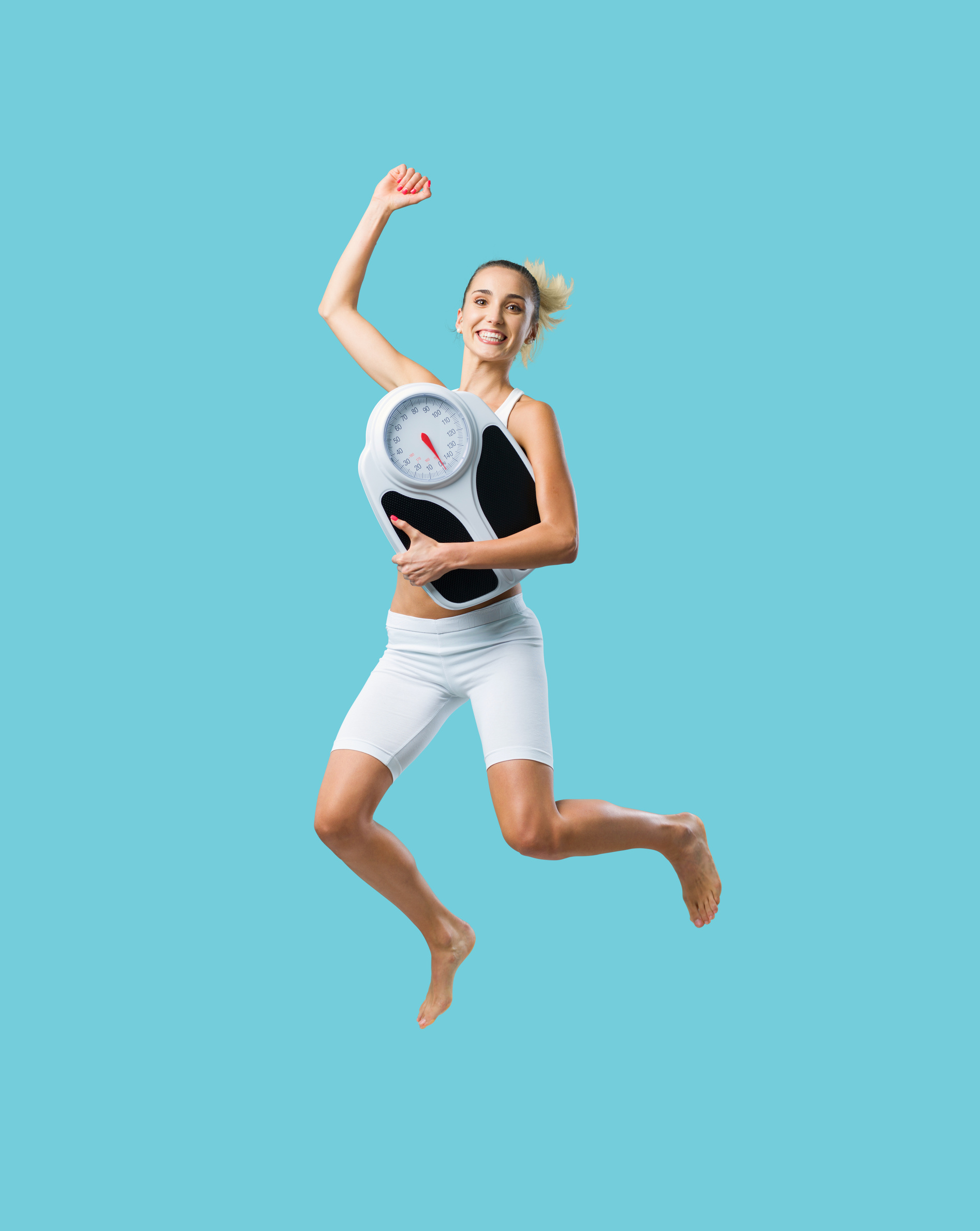 Cheerful fit woman jumping and losing weight